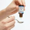 D-Omega Drops Dosing Onto A Spoon D-Omega Drops dosing onto a spoon
