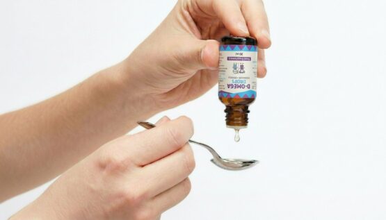 D-Omega Drops Dosing Onto A Spoon D-Omega Drops dosing onto a spoon